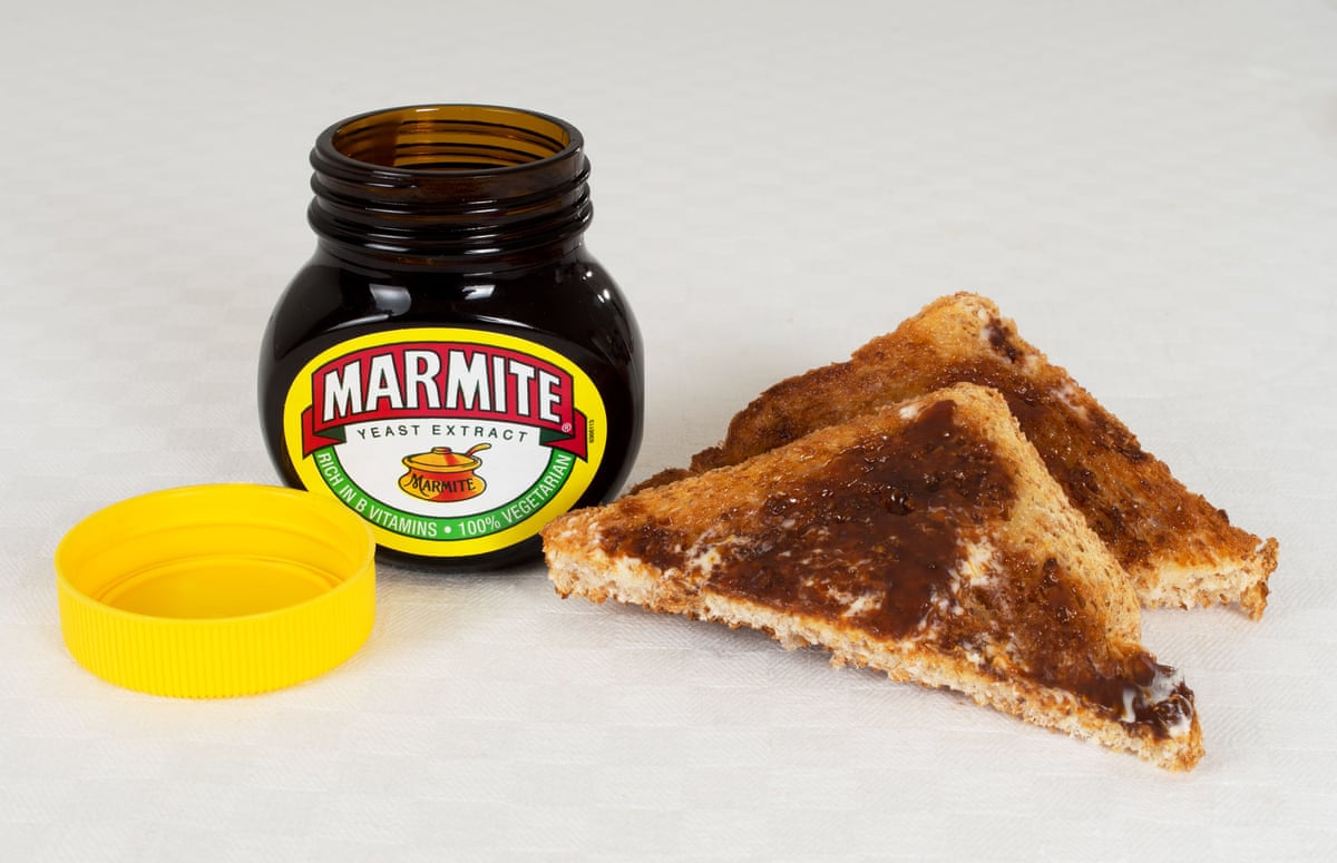 Open jar of Marmite next to toast cut into triangles