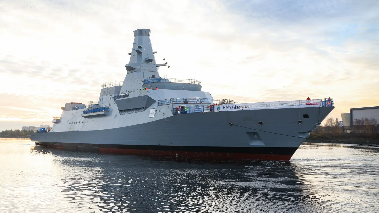 MOD/Crown Copyright A light grey warship on a river