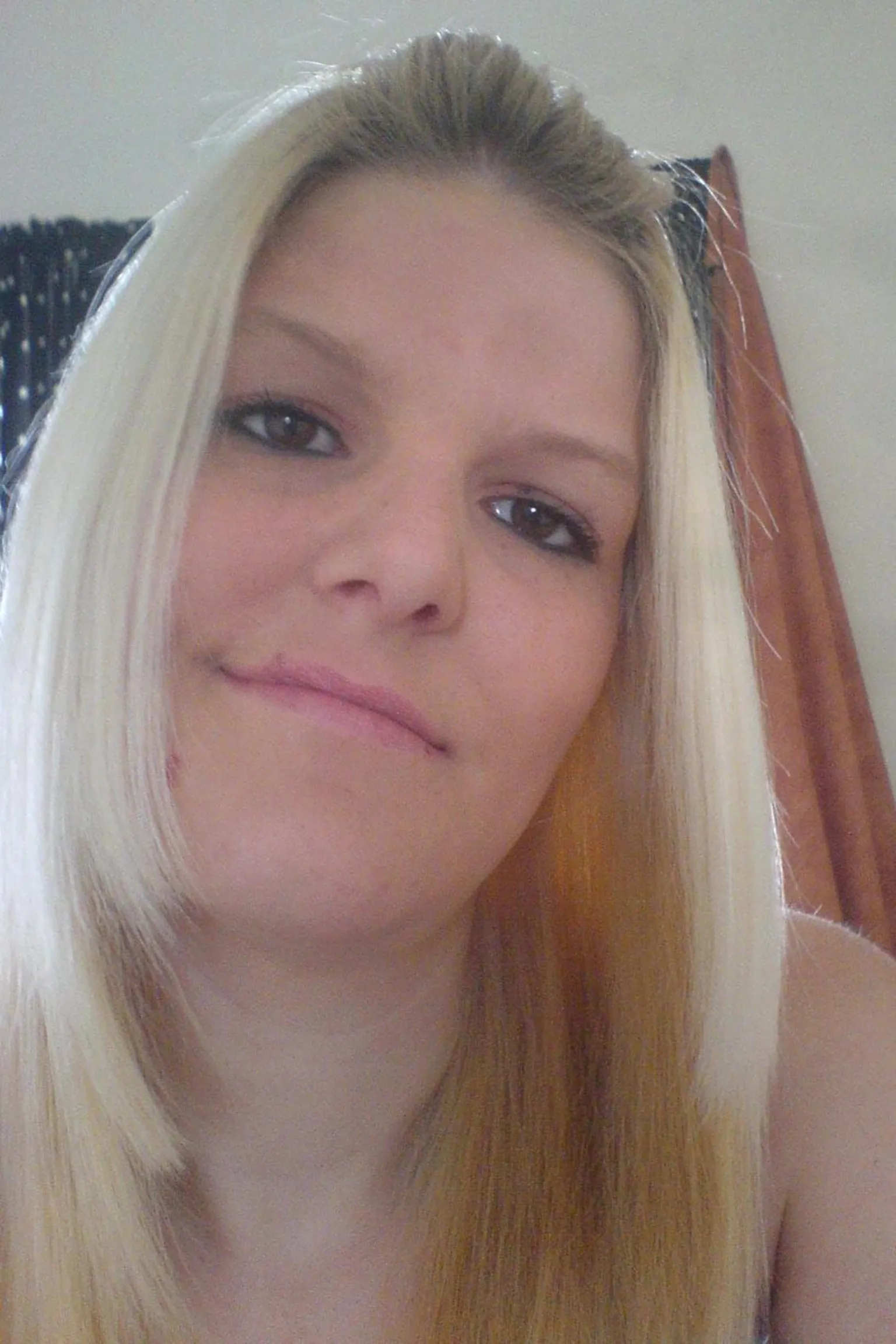 Family photo Bethan Callaghan poses for a selfie. She has blonde mid length hair, brown eyes and wears black eyeliner. She looks directly into the camera and smiles.