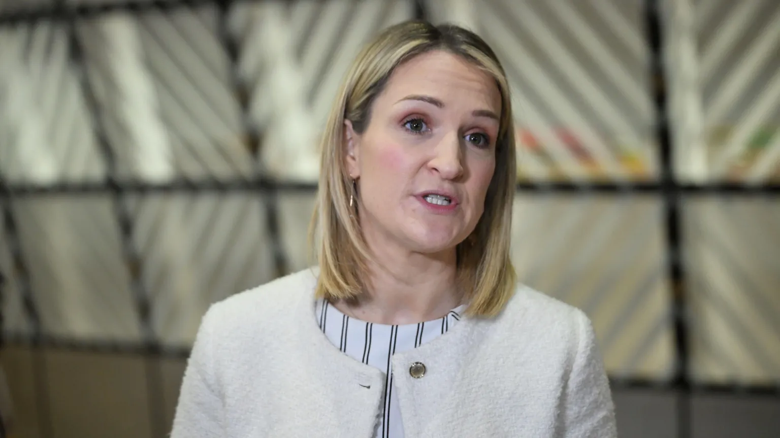  Helen McEntee, a woman with blonde hair, wearing a black and white striped blouse, with a white cardigan.