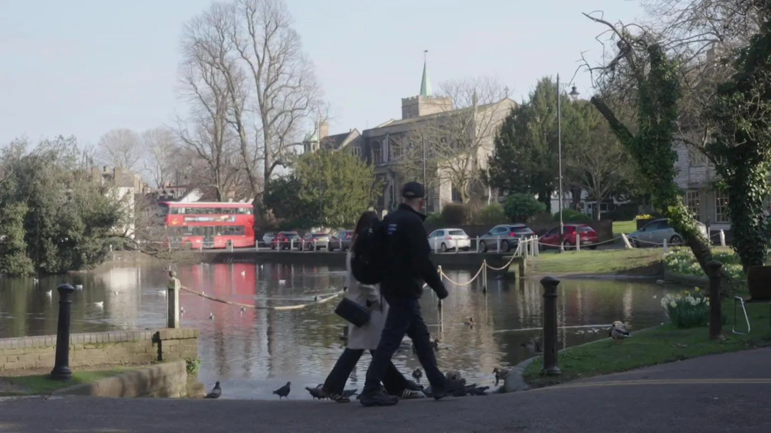 People walking past the River Wandle