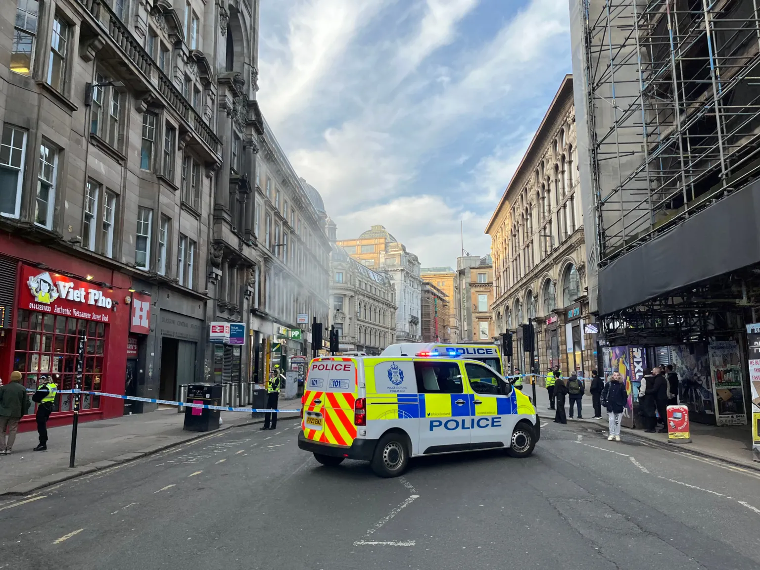 Police vehicle and cordon on a busy street in Glasgow city centre