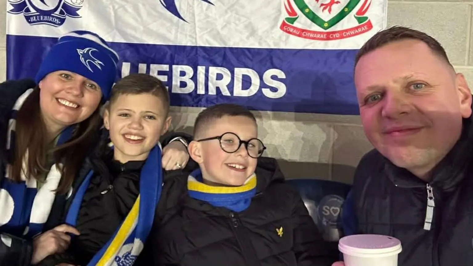 Family photo Ryder Goddard, his brother and parents David and Kirsty sat in the Cardiff City Stadium supporting their favourite team.