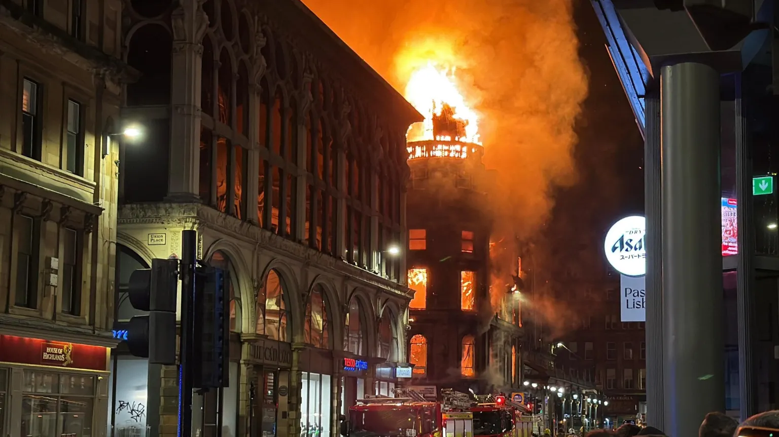 A large building on fire on a city street