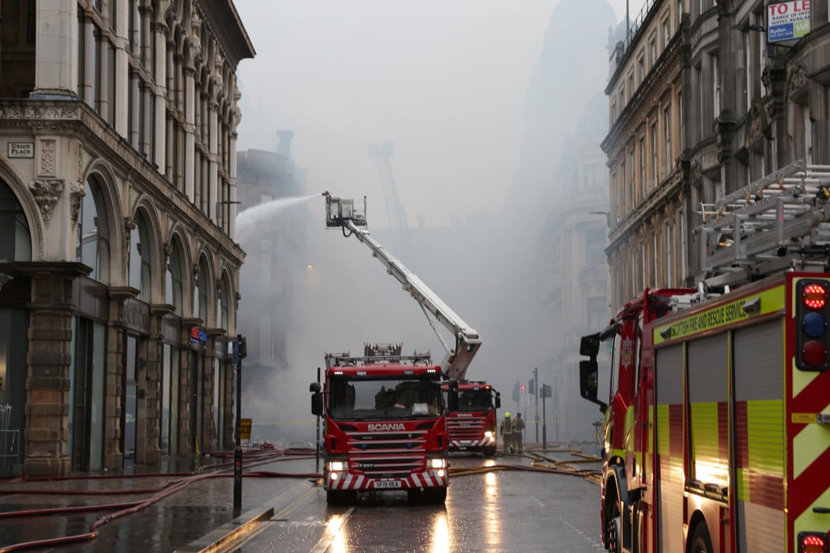 Firefighters damp down the remains of the fire next to Glasgow Central station