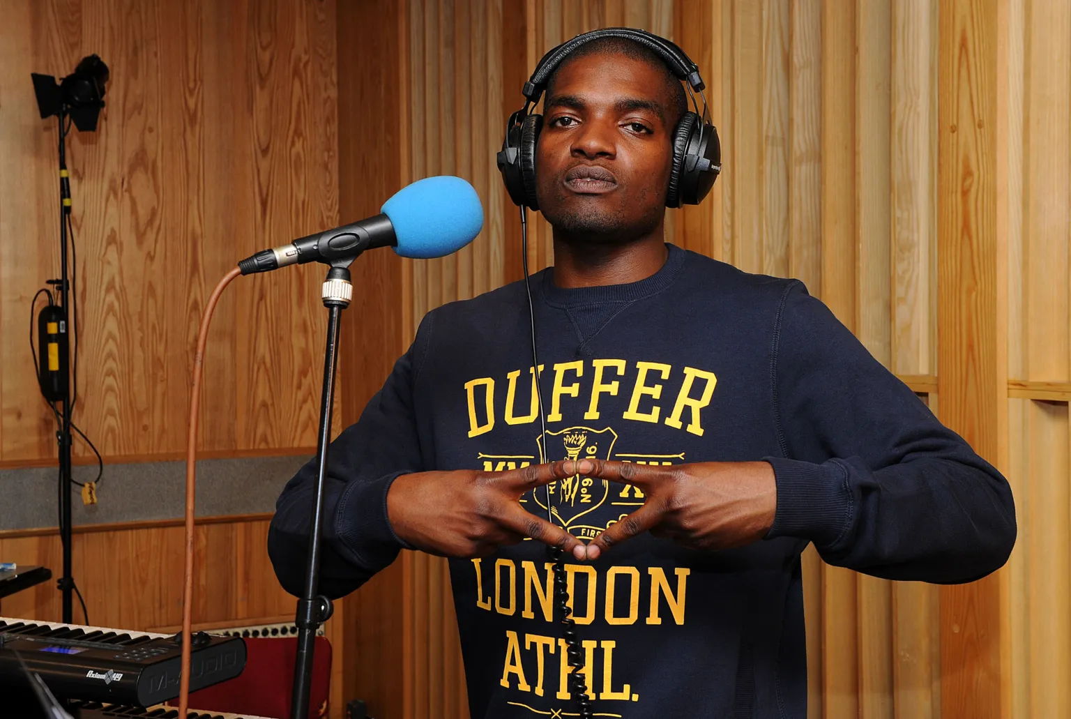 Dot Rotten in the studio at BBC Maida Vale, making a diamond shape with his fingers