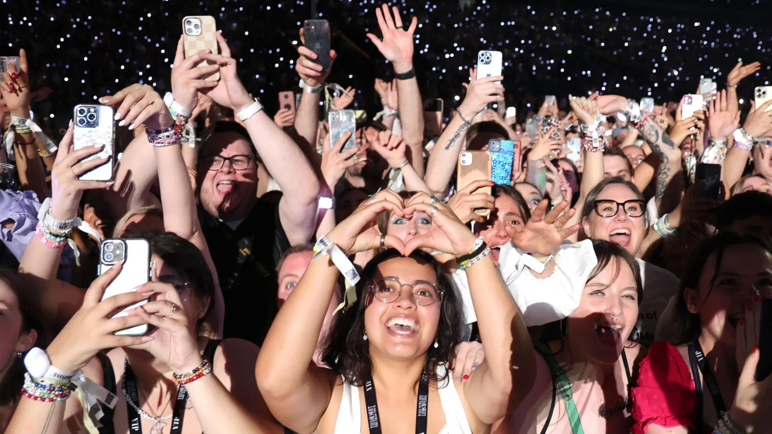  Fans watch Taylor Swift perform onstage during night two of Taylor Swift: The Eras Tour at La Defense on 10 May, 2024 in Paris, France.