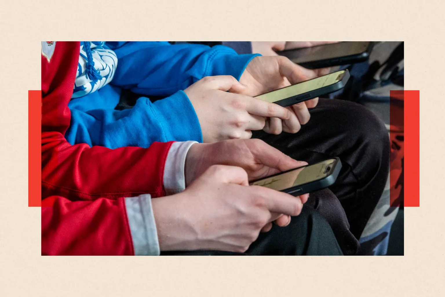  Three teenage boys looks at their smartphone screens 