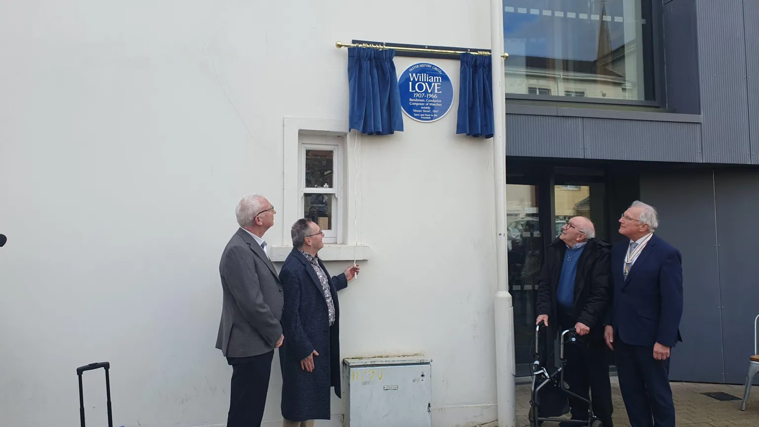 A group of people stand around 