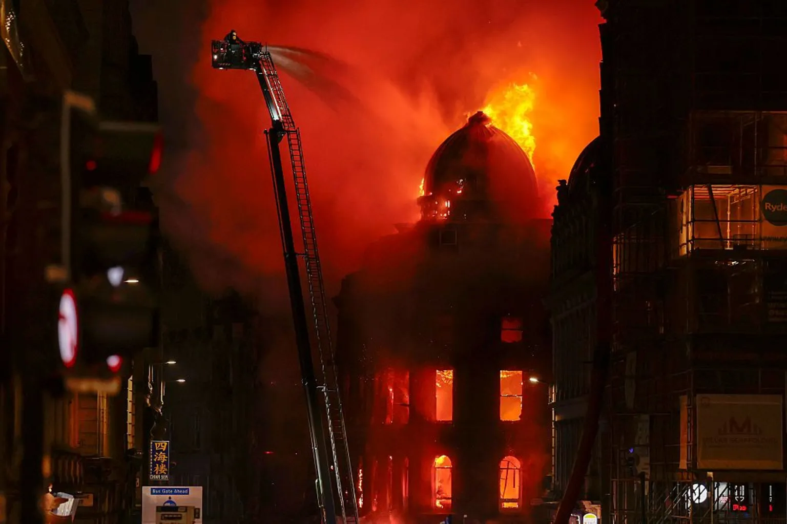 Getty Firefighters tackle a blaze from an aerial platform next to Glasgow Central Station on 8 March.