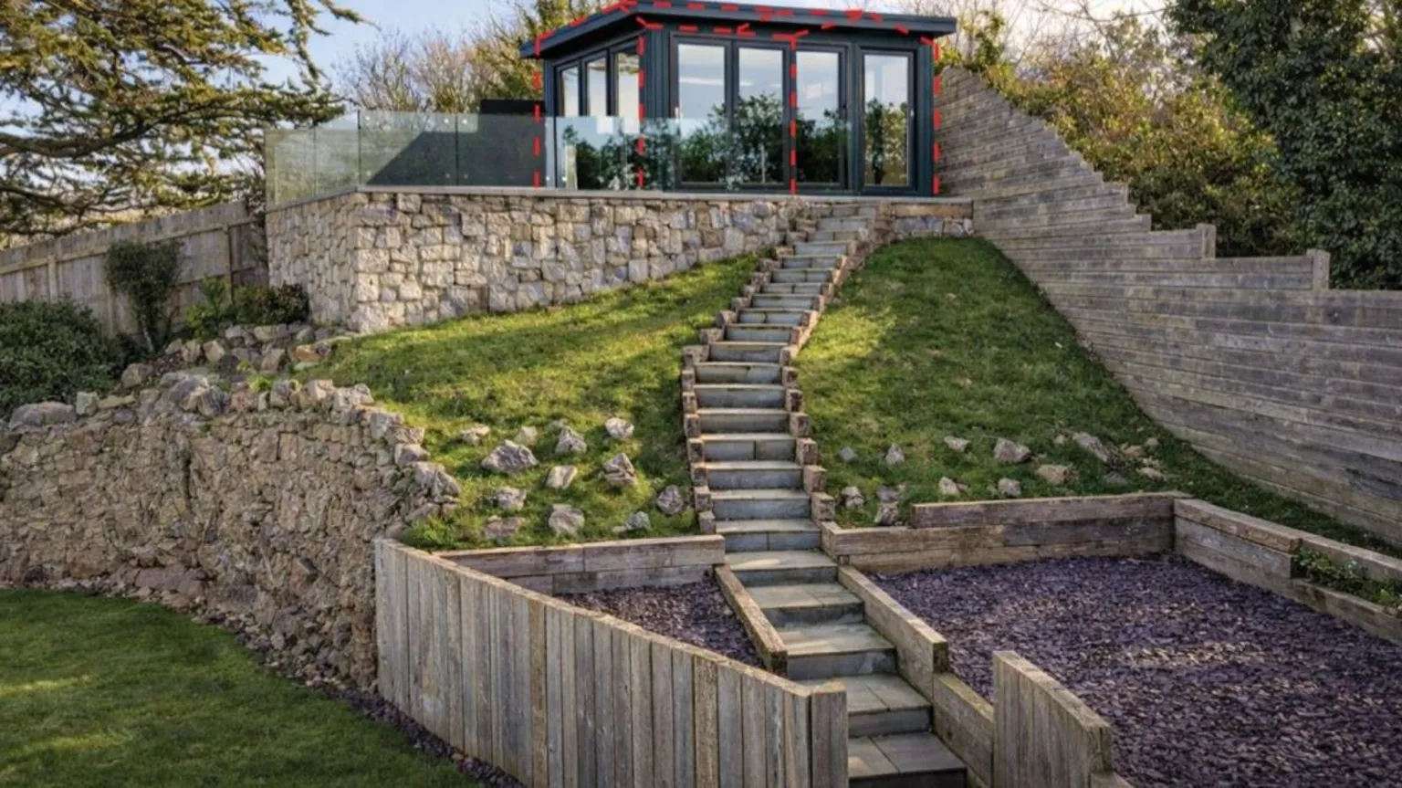 Conwy Council Glass cabin in a garden with a balcony surround