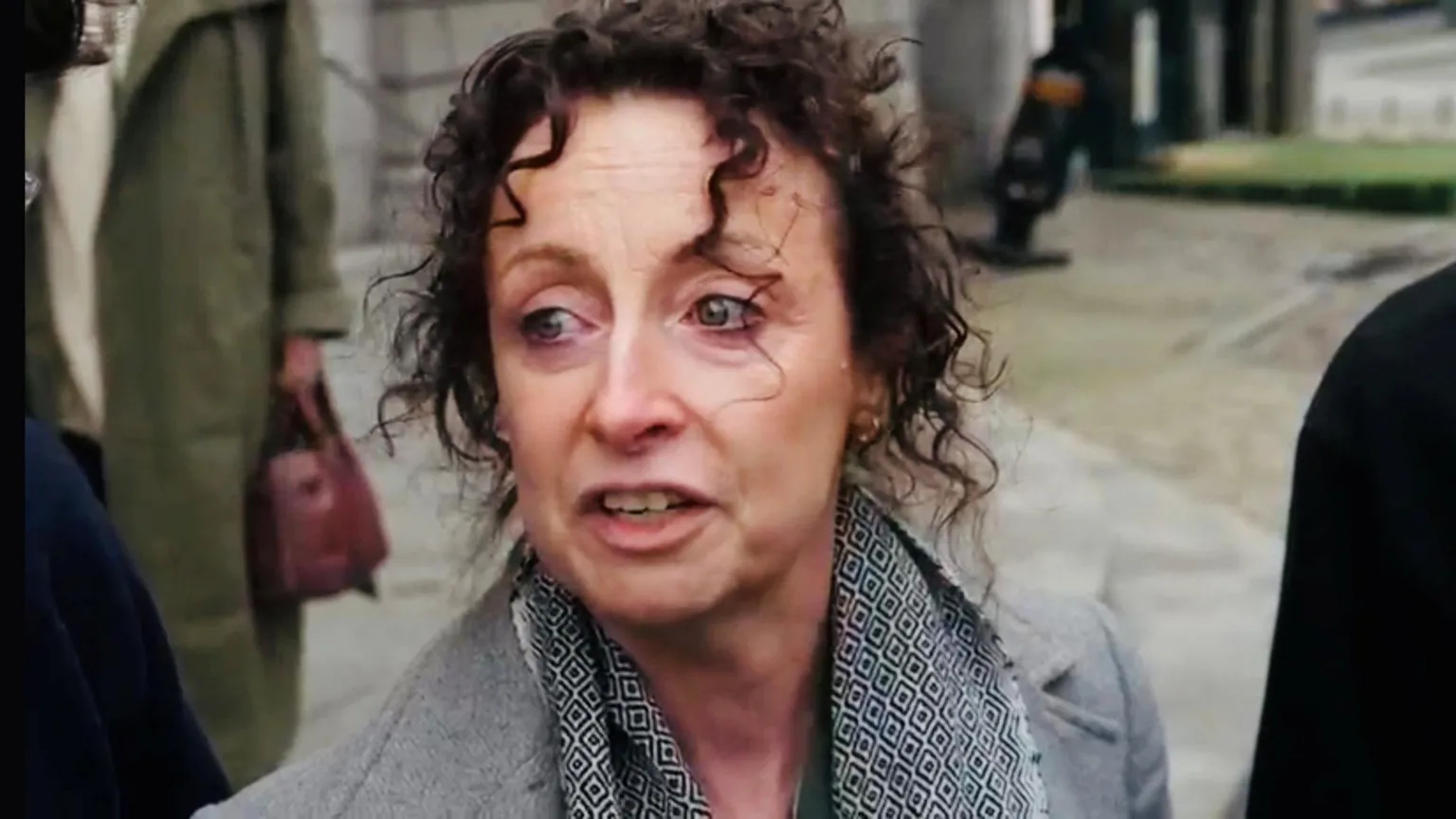 Trudi Walsh speaking outside court, she has dark hair and is wearing a grey jacket and scarf.