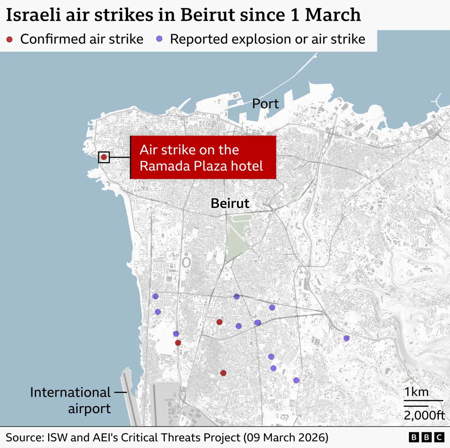A map of Beirut shows locations of Israeli air strikes and reported explosions since 1 March. The city’s coastline is at the top, with the port labelled near the upper edge and the international airport labelled at the lower left. The map is dotted with red circles indicating confirmed air strikes and purple circles indicating reported explosions or air strikes. Most of these earlier strikes cluster in the southern half of the city and around the airport area, with a few scattered to the east and southeast. A single new red marker—highlighted by a large red label reading “Air strike on the Ramada Plaza Hotel”—appears on the western side of the city near the coast, separate from the earlier cluster. This new strike is noticeably outside the areas where previous strikes or explosions have been recorded.