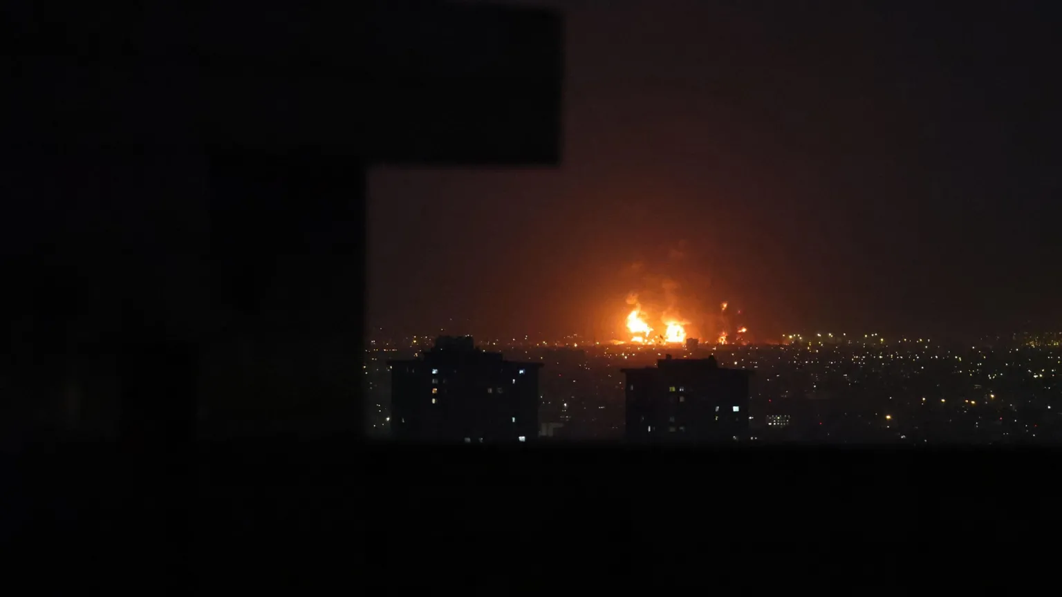 EPA Smoke rises from Tehran's oil refinery after airstrikes in Tehran, Iran, 07 March 2026. The skyline is illuminated by flames rising from the refinery. 