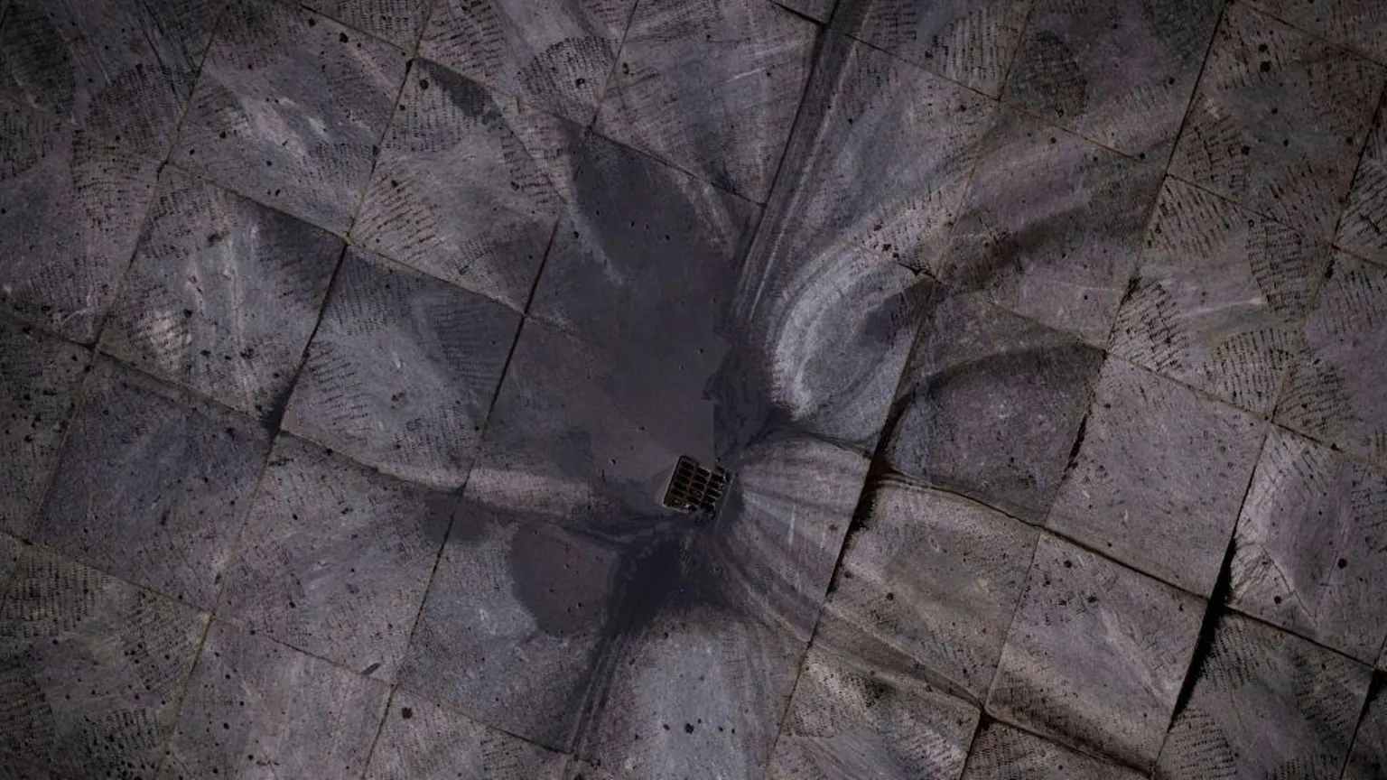  Black rainwater flows down a drain in Tehran. 