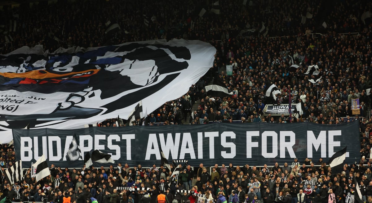 Newcastle United fans display banners in the stands.