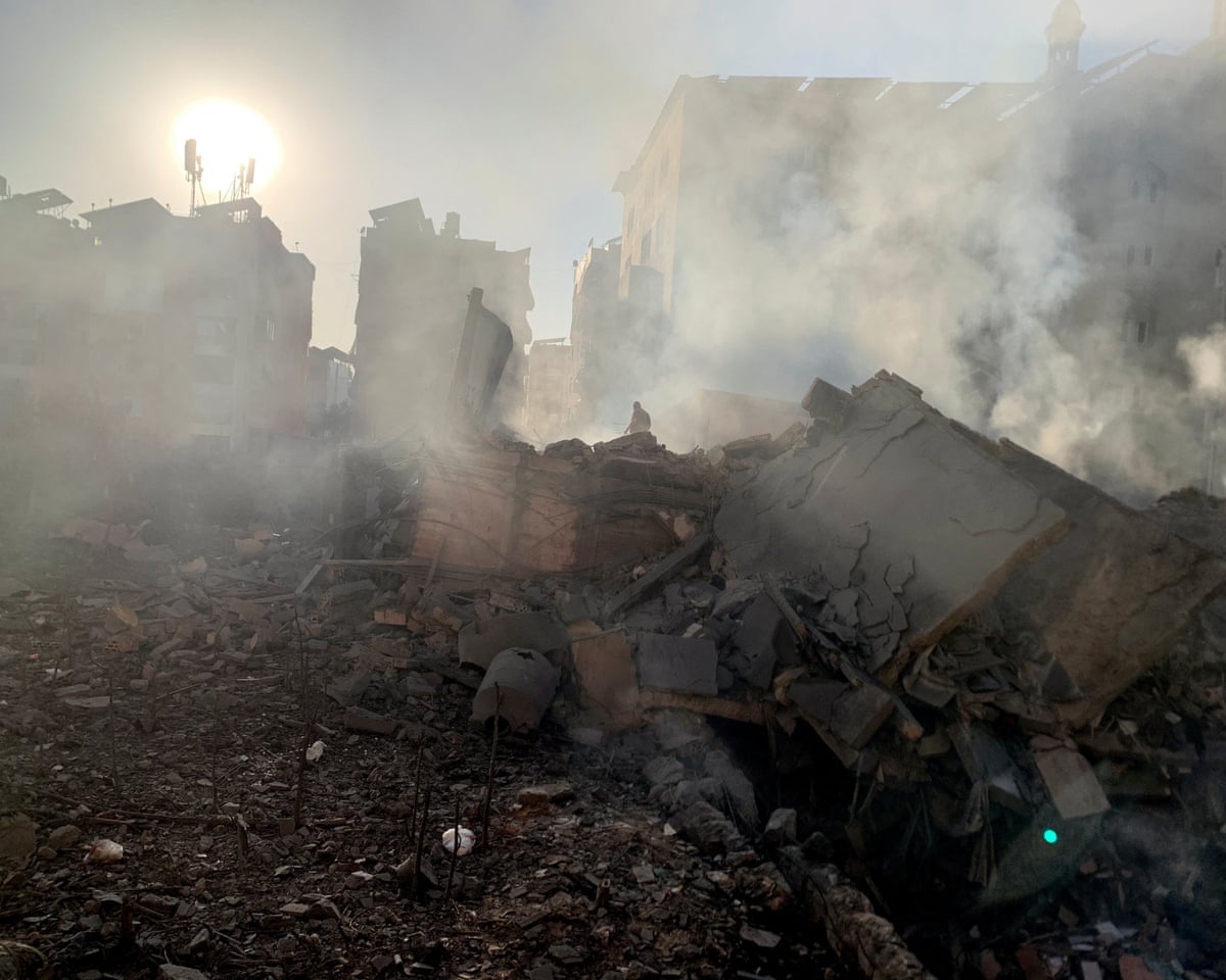 A member of the Lebanese Civil Defence inspects a destroyed building after an Israeli strike on Beirut’s southern suburbs