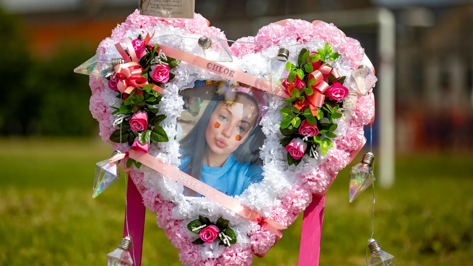 Liam McBurney/PA Wire A floral tribute arrangement in the shape of a heart. A picture of Chloe is in the middle. It is placed in a park.