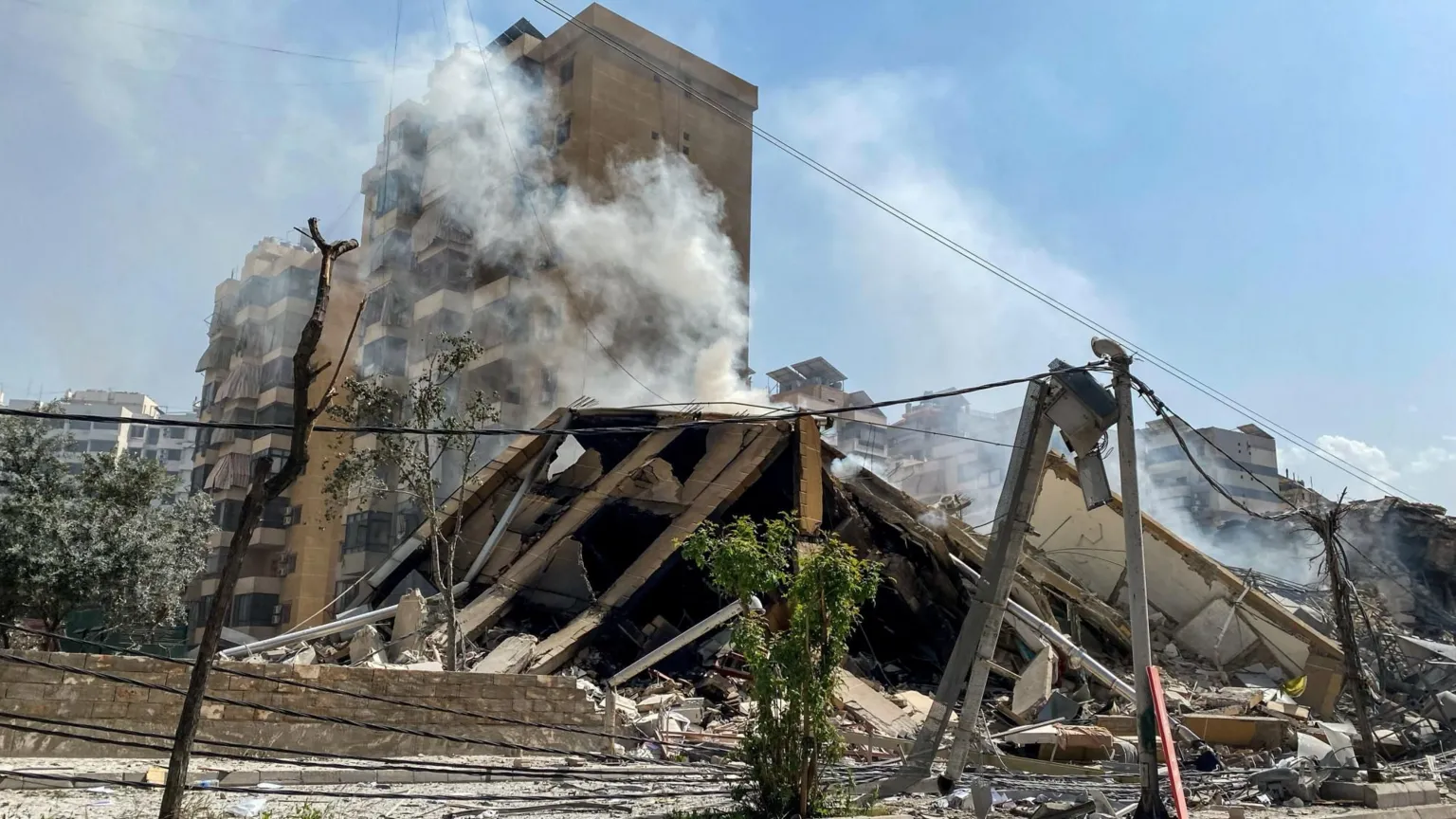  Smoke rises from a building destroyed in an Israeli strike in Beirut's southern suburbs, Lebanon (12 March 2026)