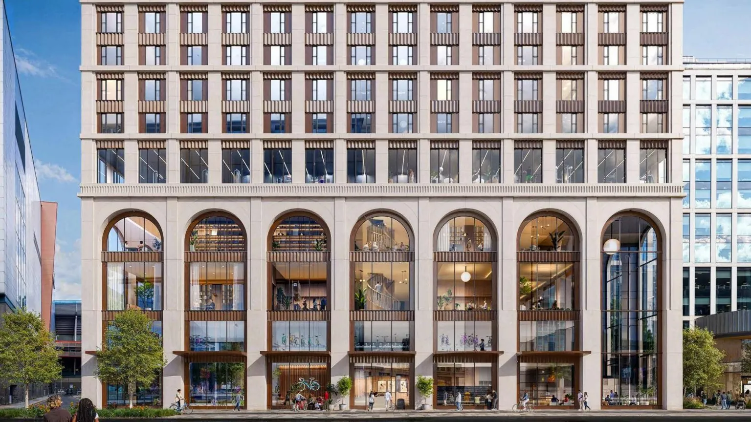 5plus Architects Seven tall arches can be seen at the front of the first four floors of the building, with smaller windows on multiple floors above.