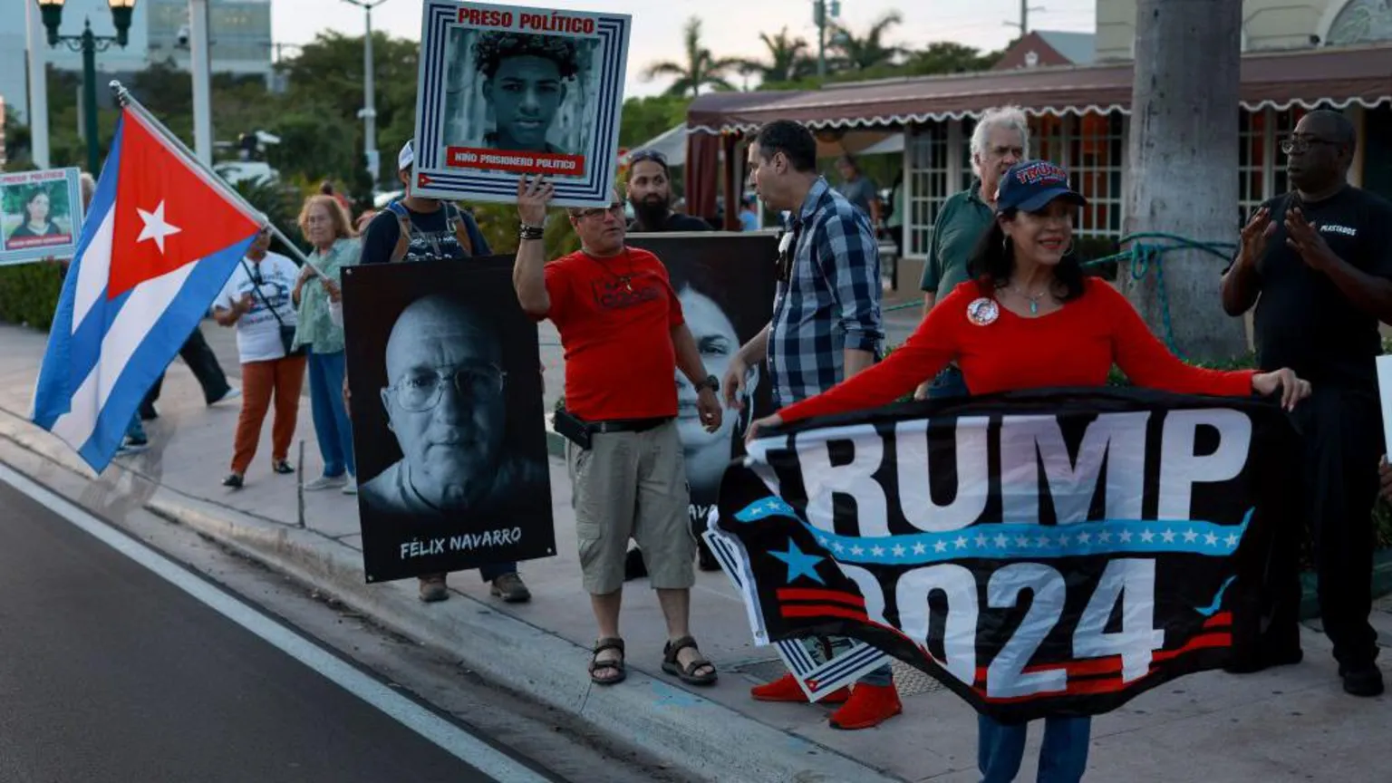  People hold photographs of political prisoners being held in Cuban jails during a demonstration in support of the protesters in Cuba on March 18, 2024, in Miami, Florida. They also hold up signs saying 