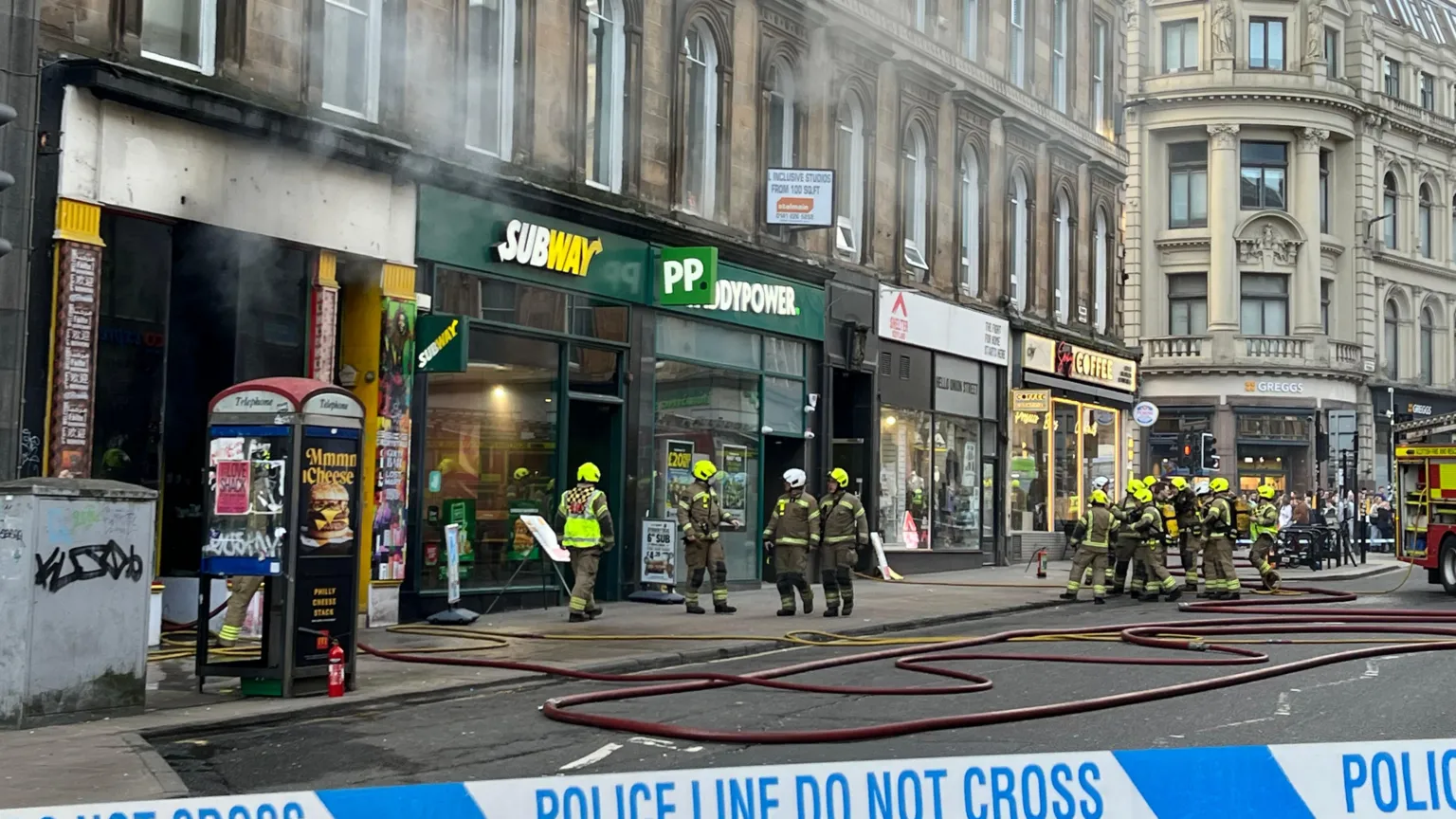Union Street in Glasgow - teams of firefighters are tackling smoke coming from a row of shops, including a Subway and a Paddy Power.