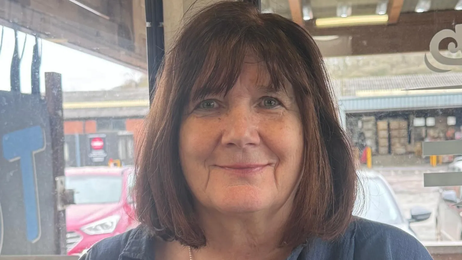 Headshot of Haycock. Brown bob with fringe