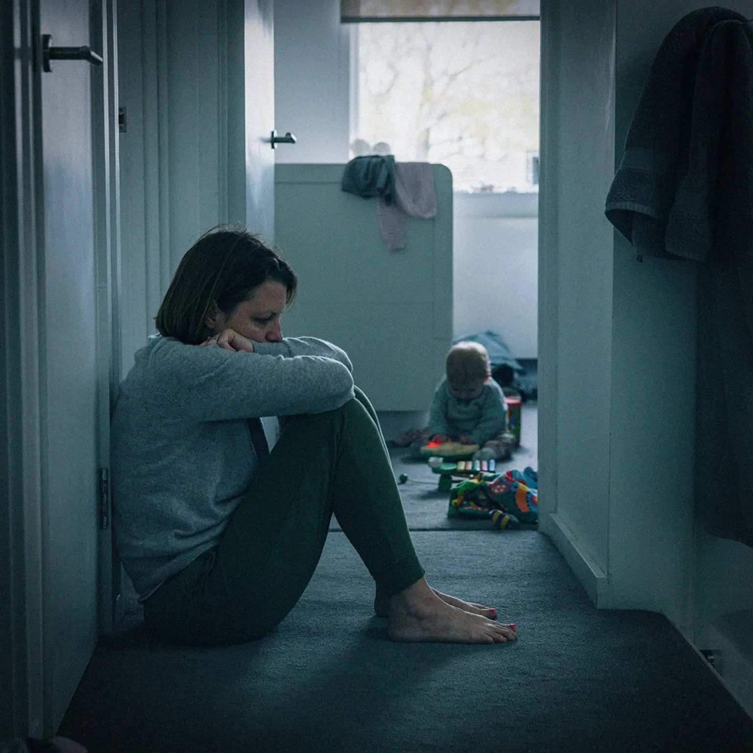  A mother slumped outside her child's bedroom