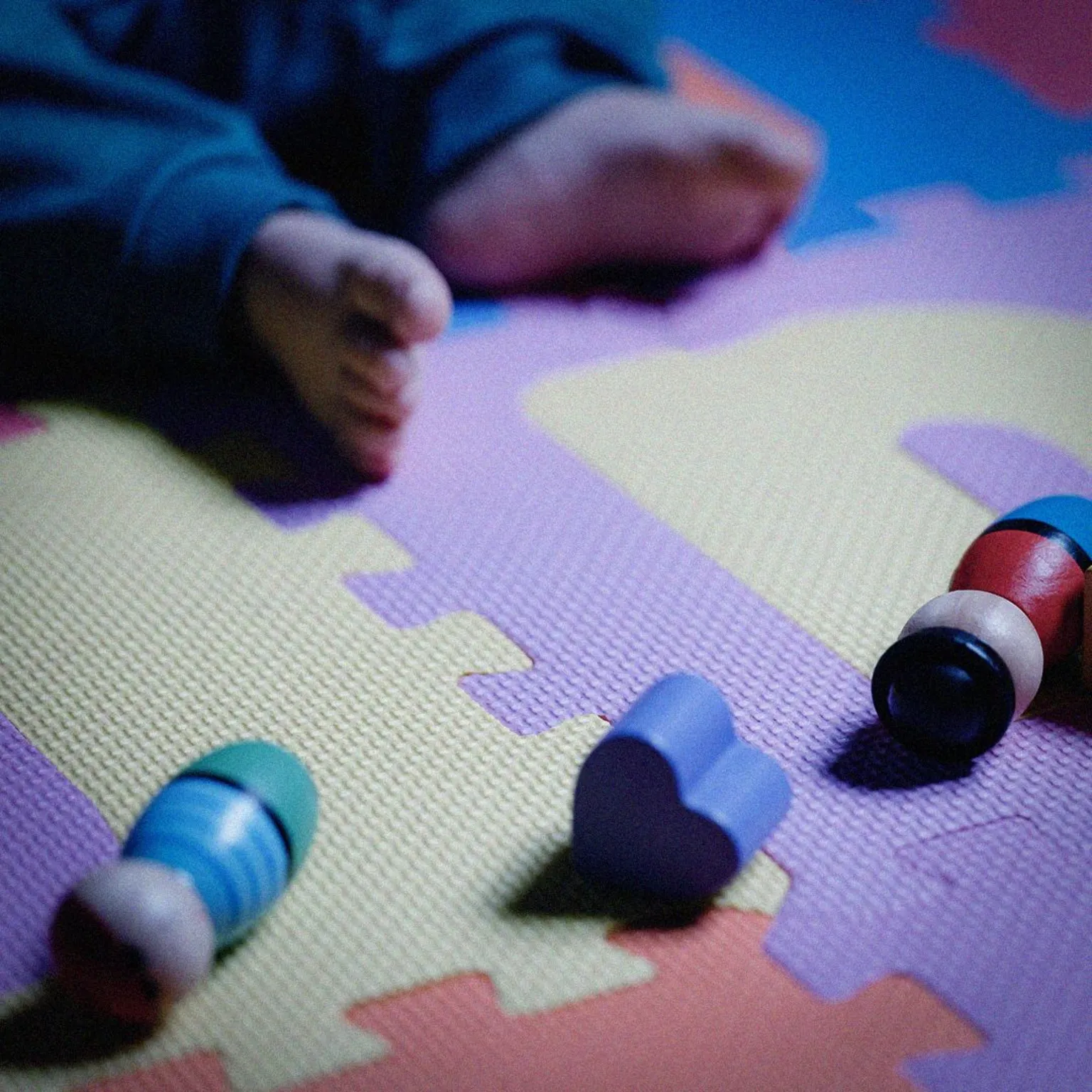  A child by some wooden toy figures