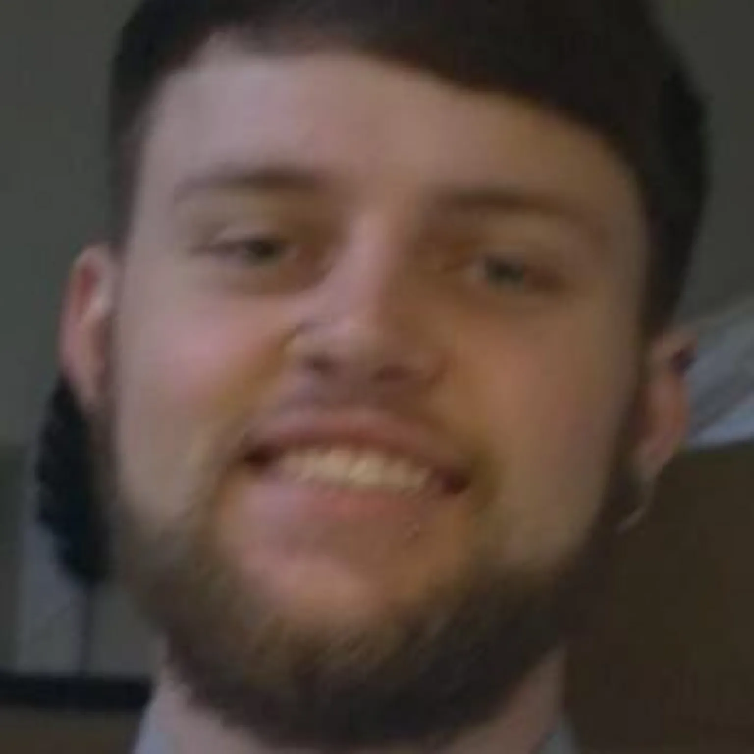 Nadine Marshall Conner, who has a light brown beard and short brown hair, smiles