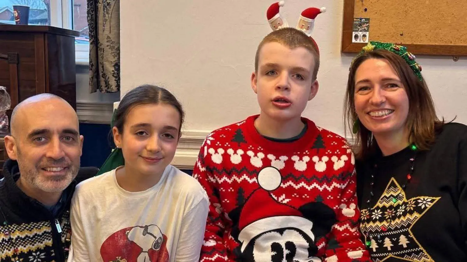 Contributed A family photo of the Sauls at Christmas time. They are all wearing Christmas inspired clothing and William has a headband on with two Santas.