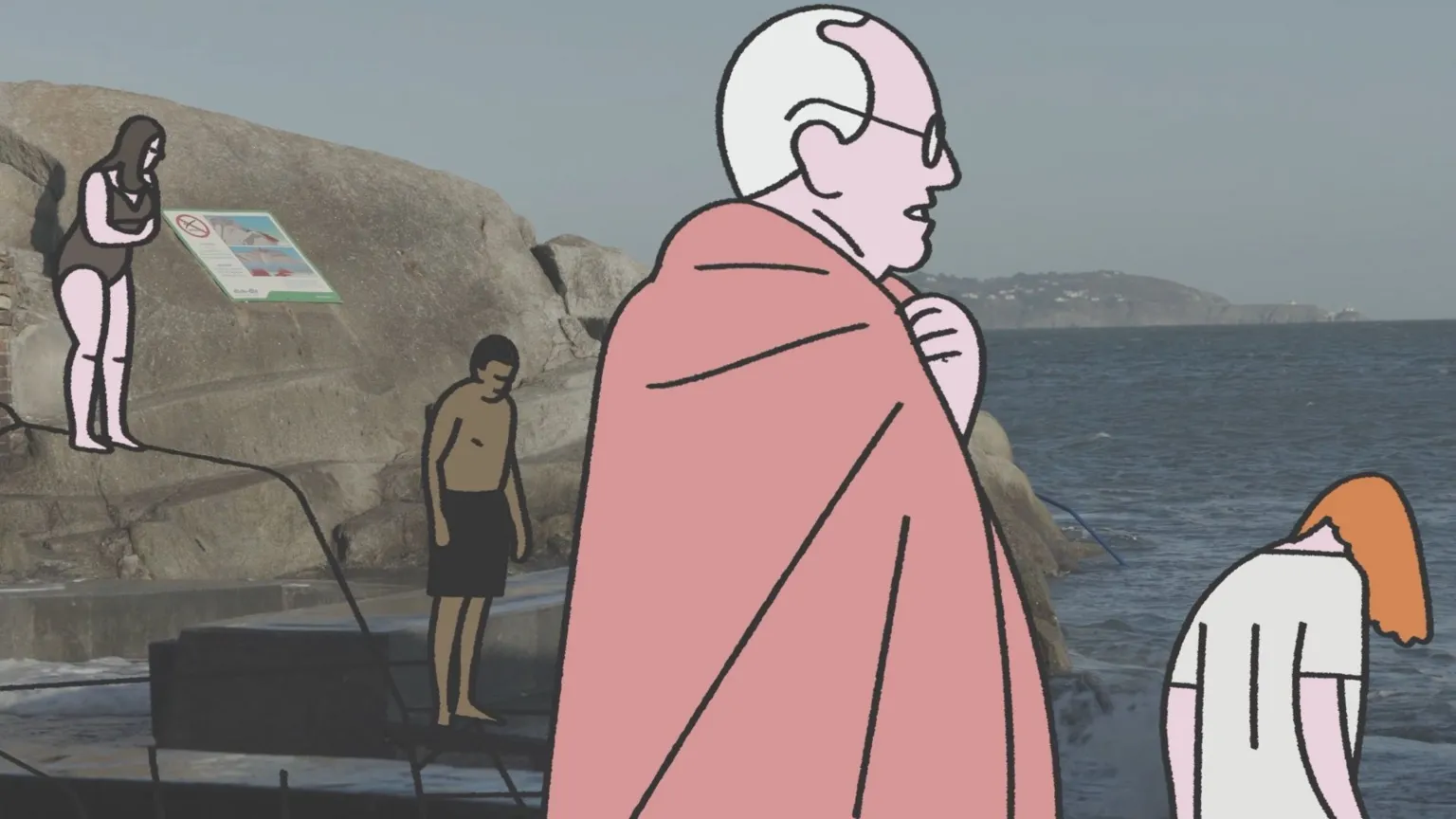John Kelly / Antidote Films An image combining illustration and photography shows several stylized characters at a rocky seaside bathing spot, the Forty Foot in Dublin. The background is a coastal scene with large rock formations, calm water, and distant hills under a clear sky. Over this photographic setting, illustrated figures are placed: one figure wrapped in a large pink towel stands prominently in the center; another illustrated figure with orange hair bends forward near the water; a figure in a dark swimsuit stands on a rock to the left; and another illustrated figure, wearing dark shorts, stands near the water’s edge.
