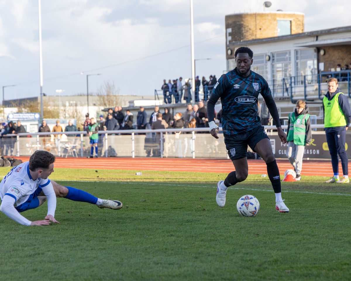 Dagenham & Redbridge captain Christian Maghoma runs with the ball in his team's 0-0 draw away to Enfield Town in the National League South.
