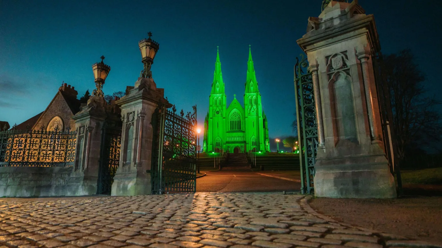  St Patrick's Church of Ireland Cathedral in Armagh, glowing green in celebration of St Patrick's Day.