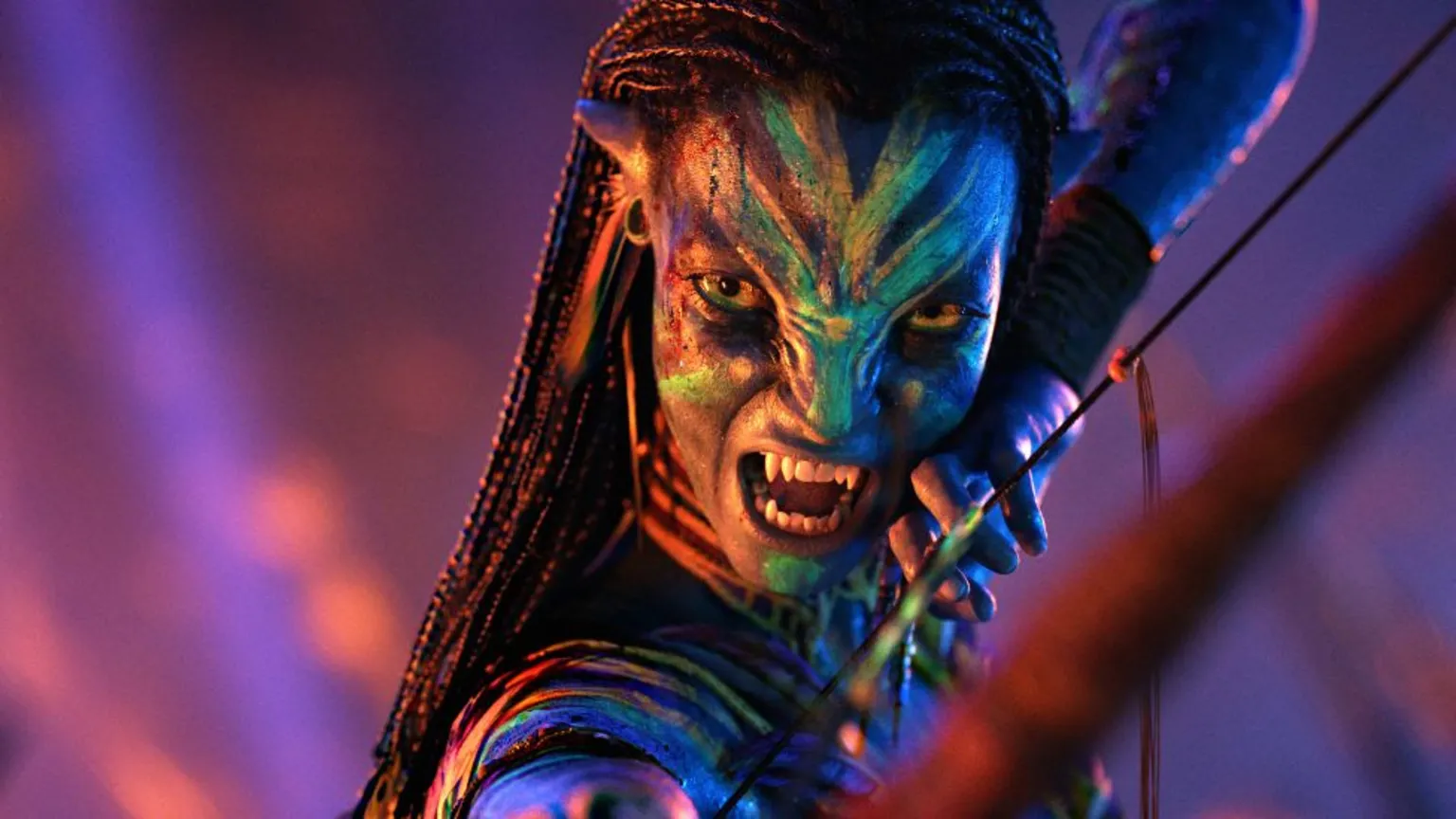 20th Century Studios Zoe Saldaña as Neytiri te Tskaha Mo'at'ite in Avatar, pictured holding a bow and arrow