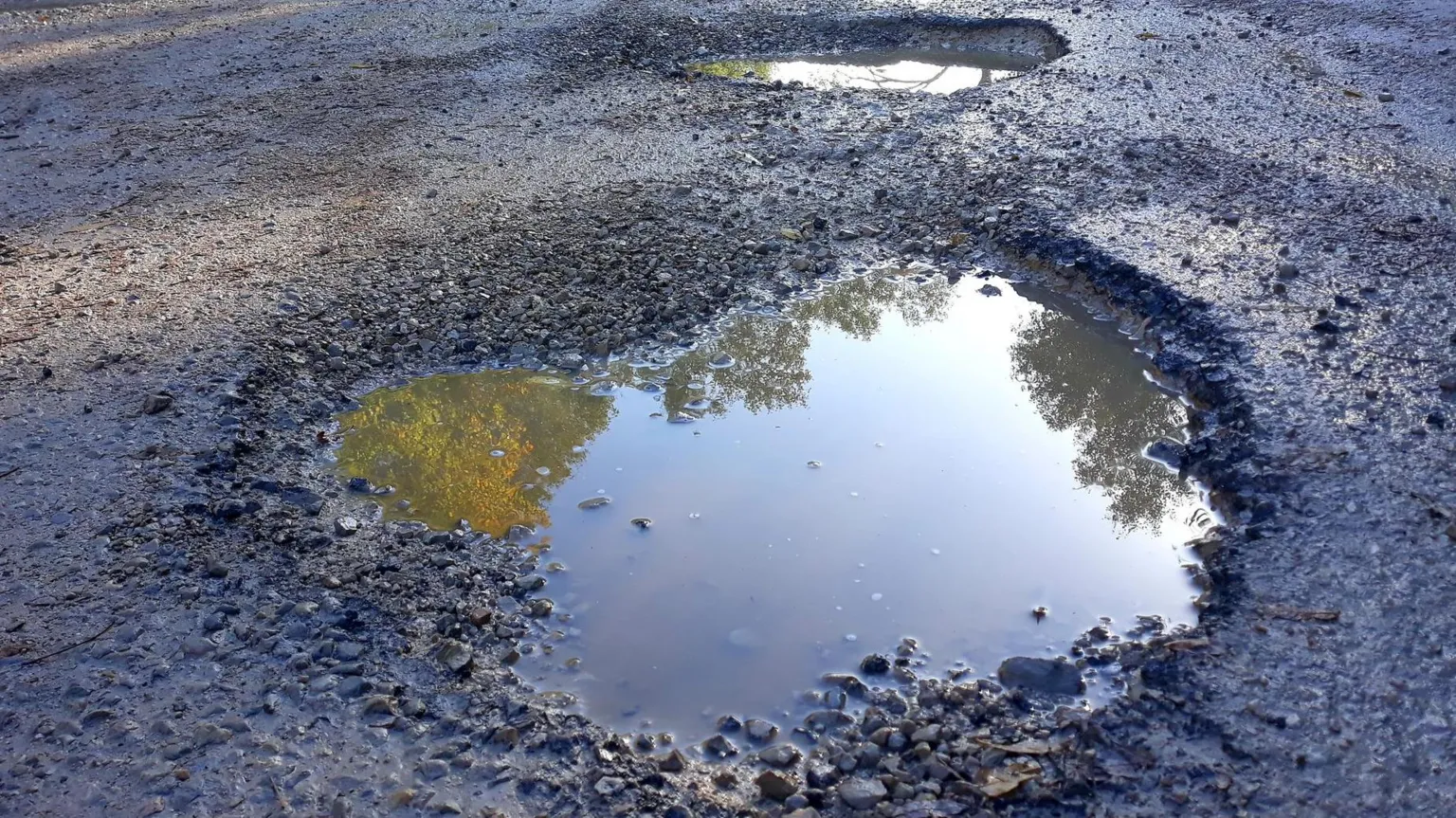 A pothole on an asphalt road
