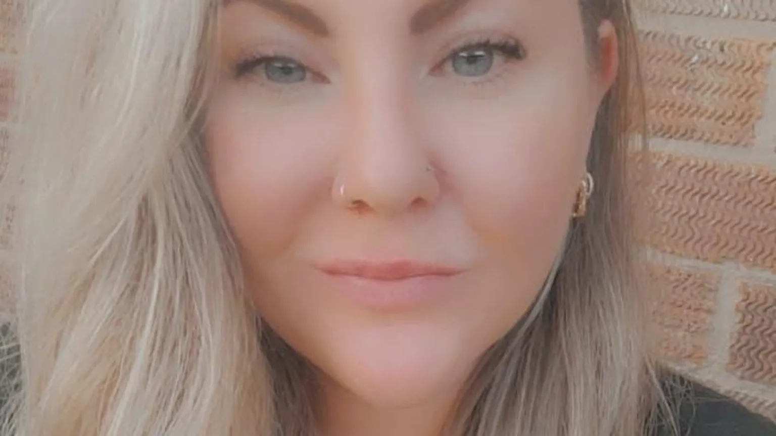 Kayleigh Glendon Kayleigh, a woman in her 30s with long blonde hair, standing in front of a red brick building