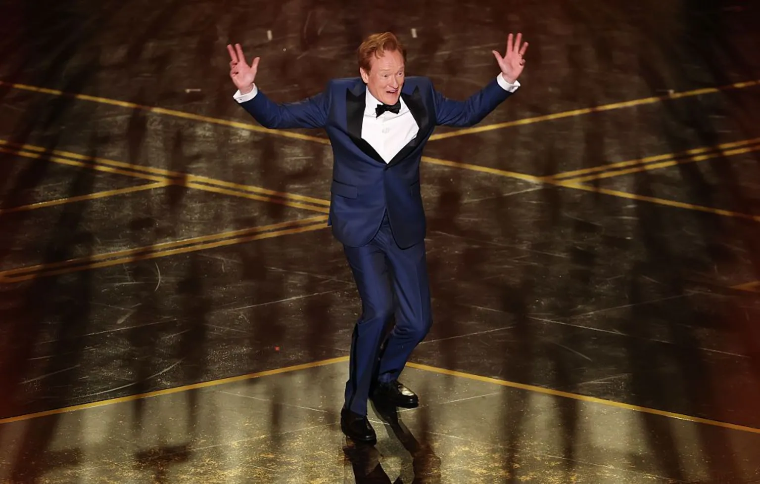  Conan O'Brien jumps with his hands in the air while hosting the 98th Academy Awards.