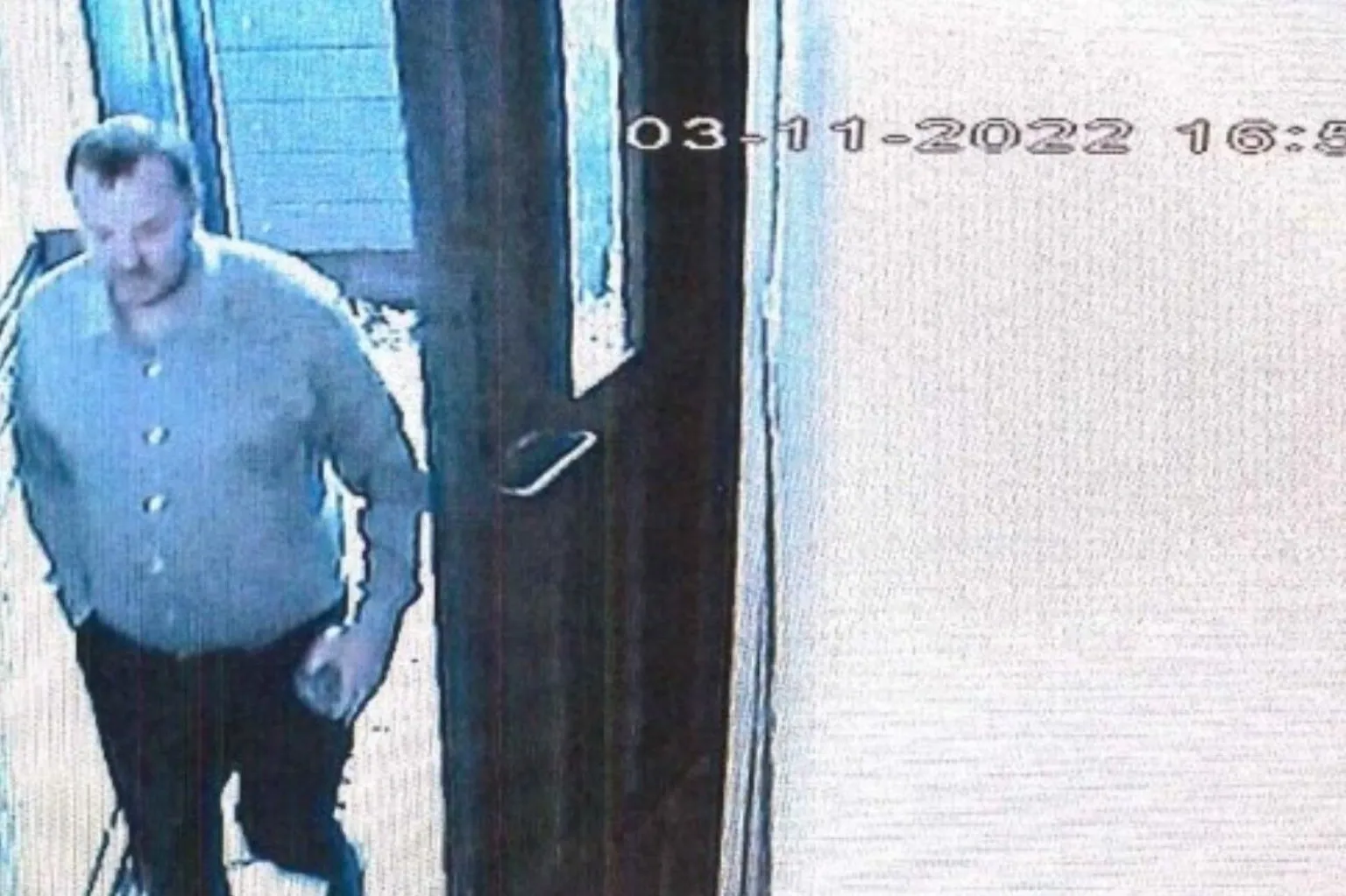 Crown Office A CCTV still of a man with a blue shirt and black trousers entering a block of flats