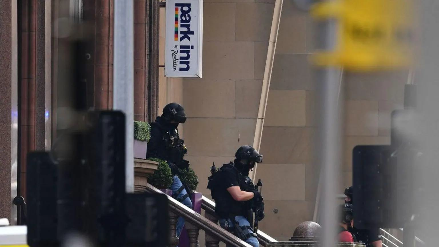  Armed officers leaving the Park Inn in Glasgow in June 2020. The officers are wearing helmets, protective clothing and carrying guns. 