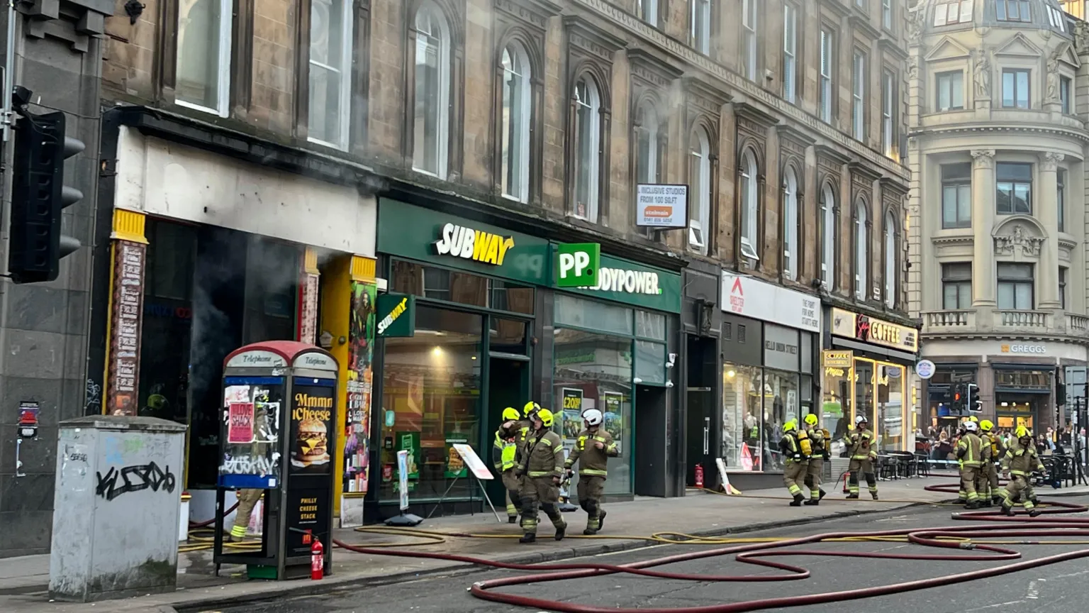 Union Street in Glasgow - teams of firefighters are tackling smoke coming from a row of shops, including a Subway sandwich and a Paddy Power.