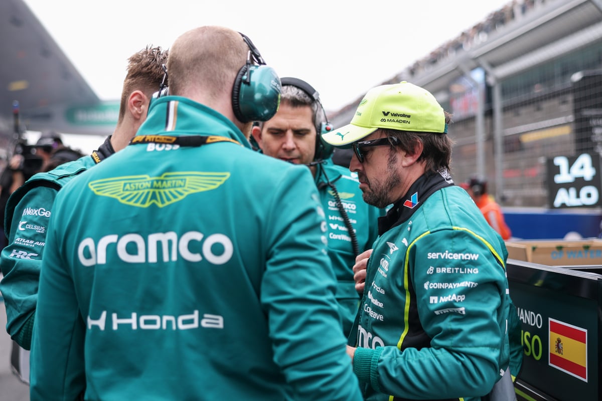 Fernando Alonso (right) talks with Aston Martin staff during the China GP.