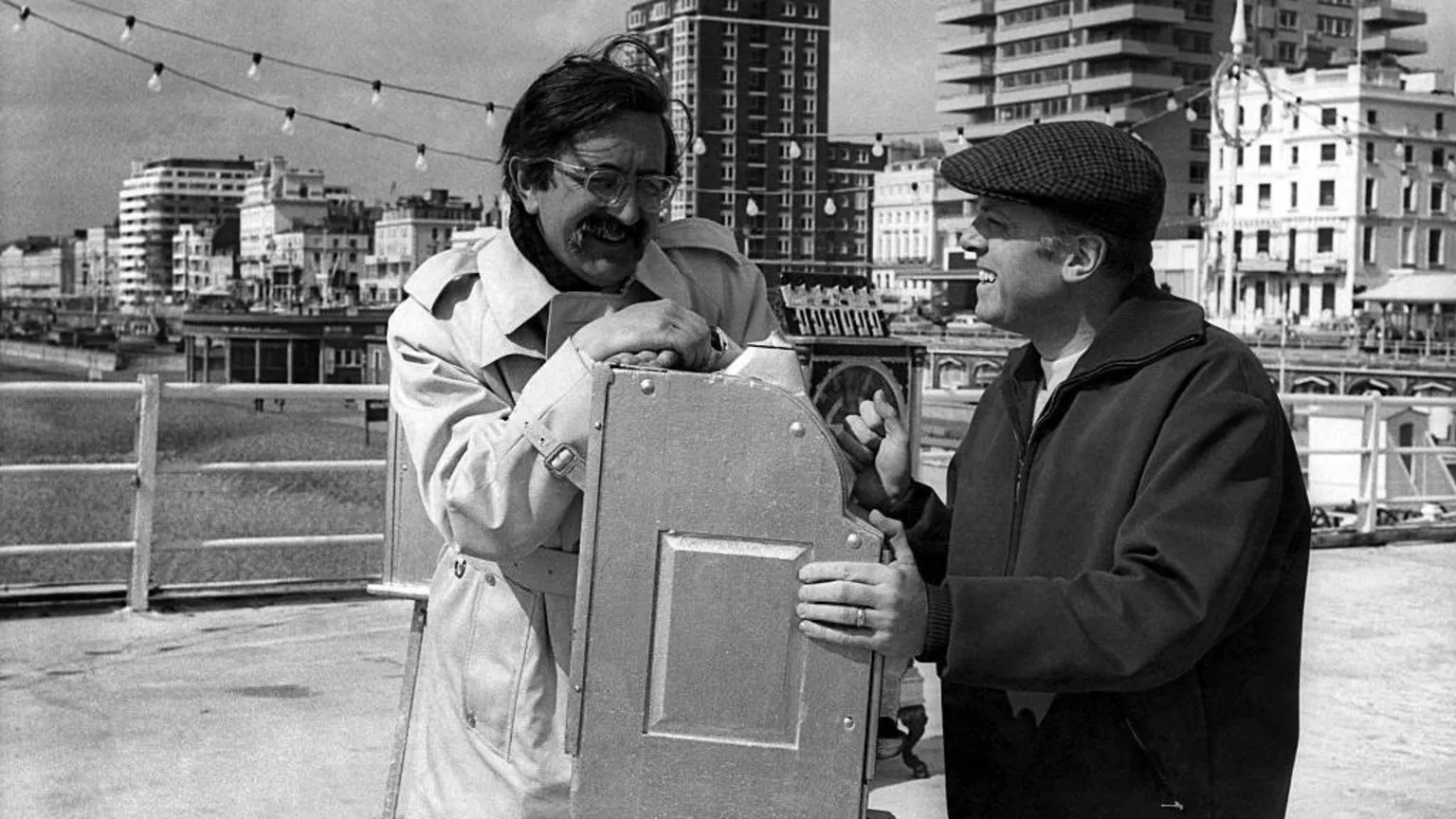  Len Deighton and Richard Attenborough photographed during filming for Oh! What A Lovely War. This is a black and white photo taken on a pier.