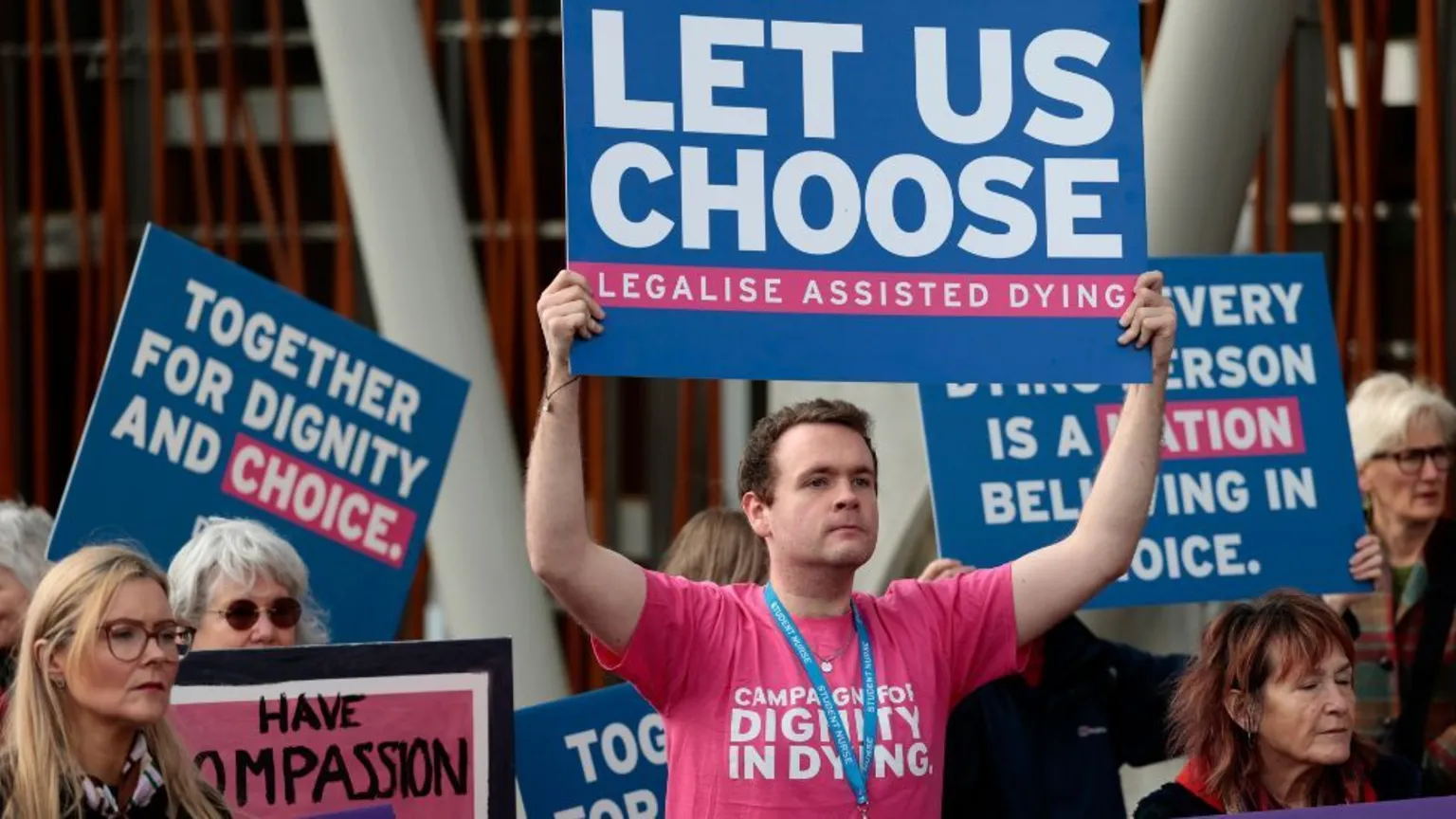  Protesters hold colourful signs in favour of assisted dying 