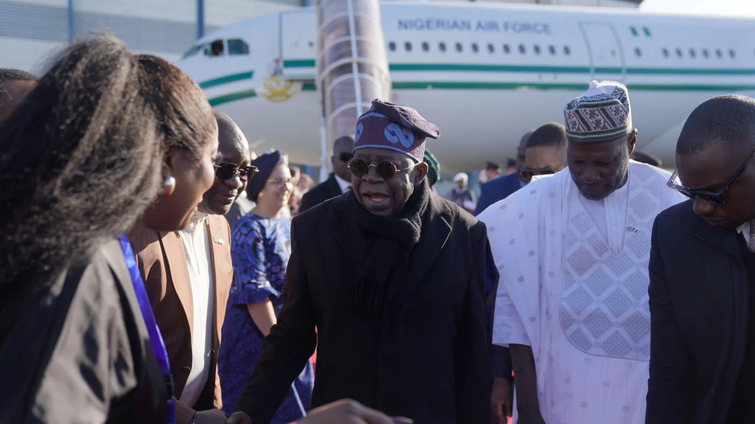  President Tinubu arriving at Stansted airport, with a Nigerian Air Force plane behind him