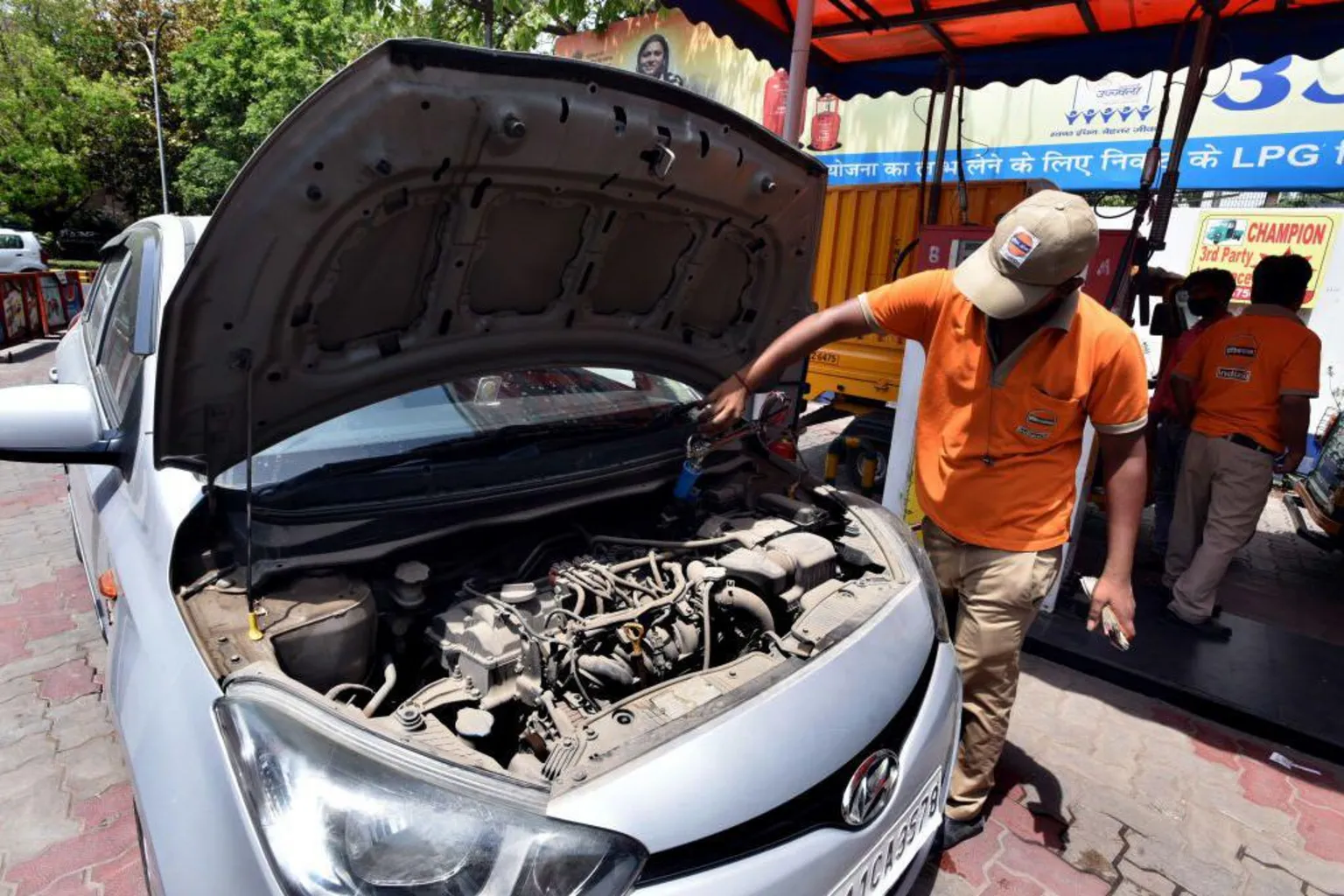 Hindustan Times via An employee Handle CNG Gas dispenser for refuel CNG Vehicle fueling facility at CNG pump station Gole Market on April 14, 2022 in New Delhi, India. 