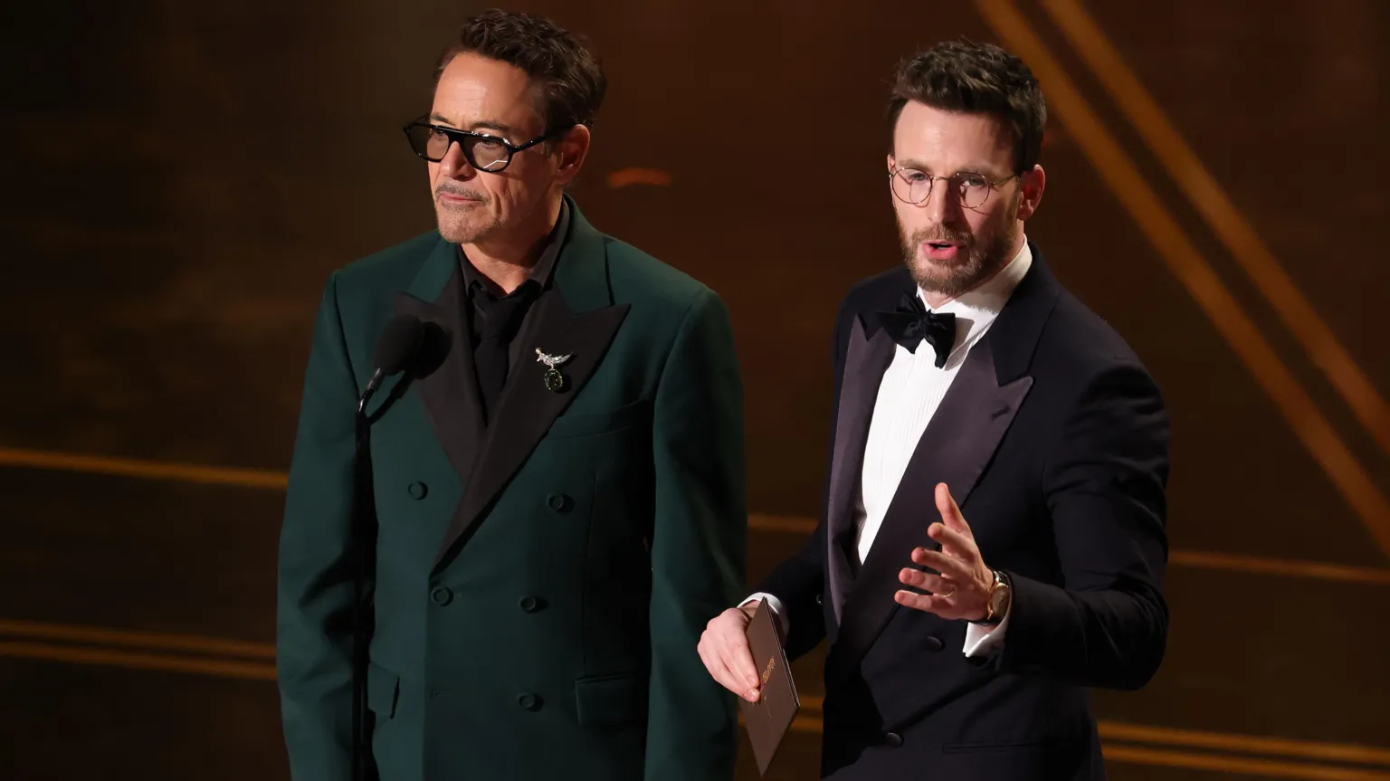  Robert Downey Jr. and Chris Evans speak onstage during the 98th Oscars at Dolby Theatre on March 15, 2026 in Hollywood, California
