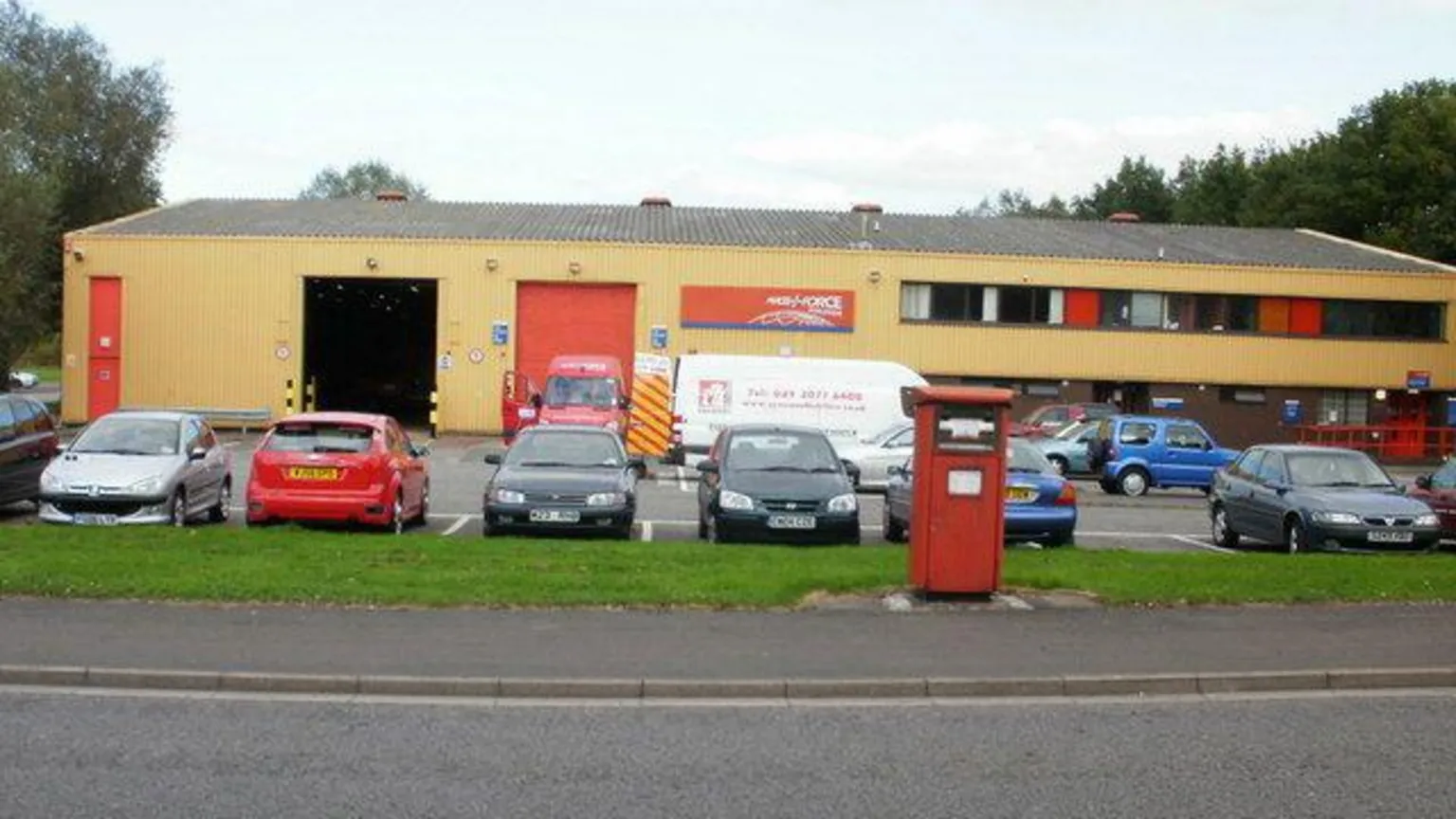 Jaggery / Geograph.org.uk An outside view of the cream-coloured depot, with cars parked outside. 