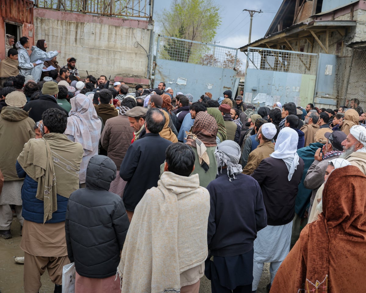 Relatives stand outside a drug rehabilitation centre destroyed in a Pakistani airstrike