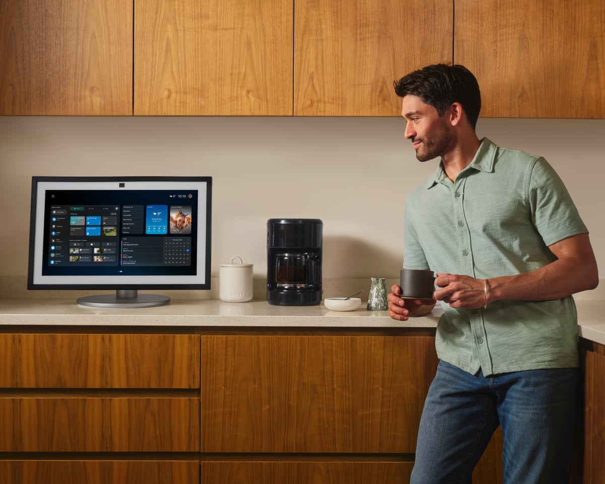 Alexa+ running on an Echo Show 15 on a kitchen work surface with a man drinking coffee.